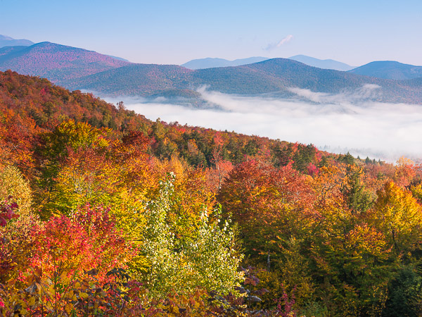Cool autumn morning fog breaks away in the White Mountains of New Hampshire.   A sunny perfect day for strolling through the...