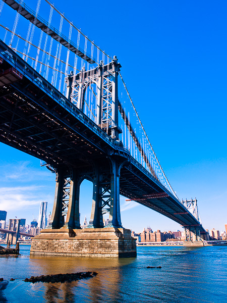 Spreading across the water the Manhattan Bridge stands tall.