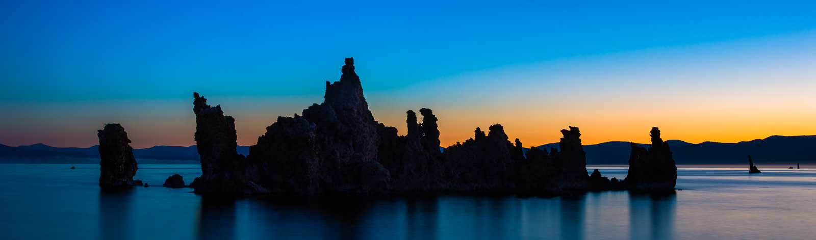 Silhouettes of tufa's highlight the sunrise. They create unique formations that scatter across the lake's waters.