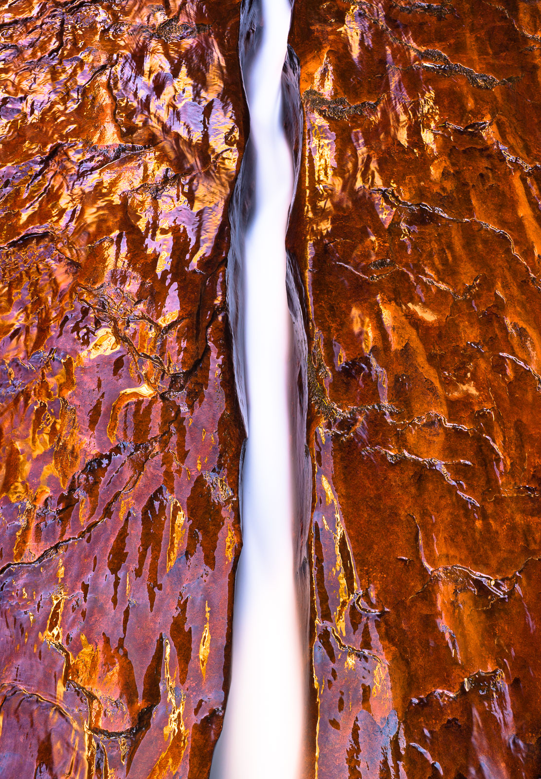 A treasure of the desert lands, this carved out channel is illuminated by reflected sun light from the canyon walls.